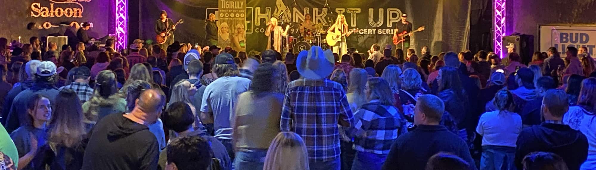 country concert with fans wearing cowboy hats Nashville
