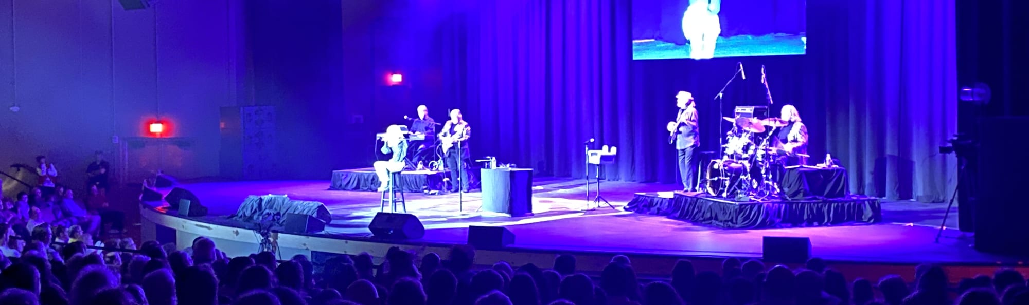 signer on stage in chair washed out by the lights Nashville