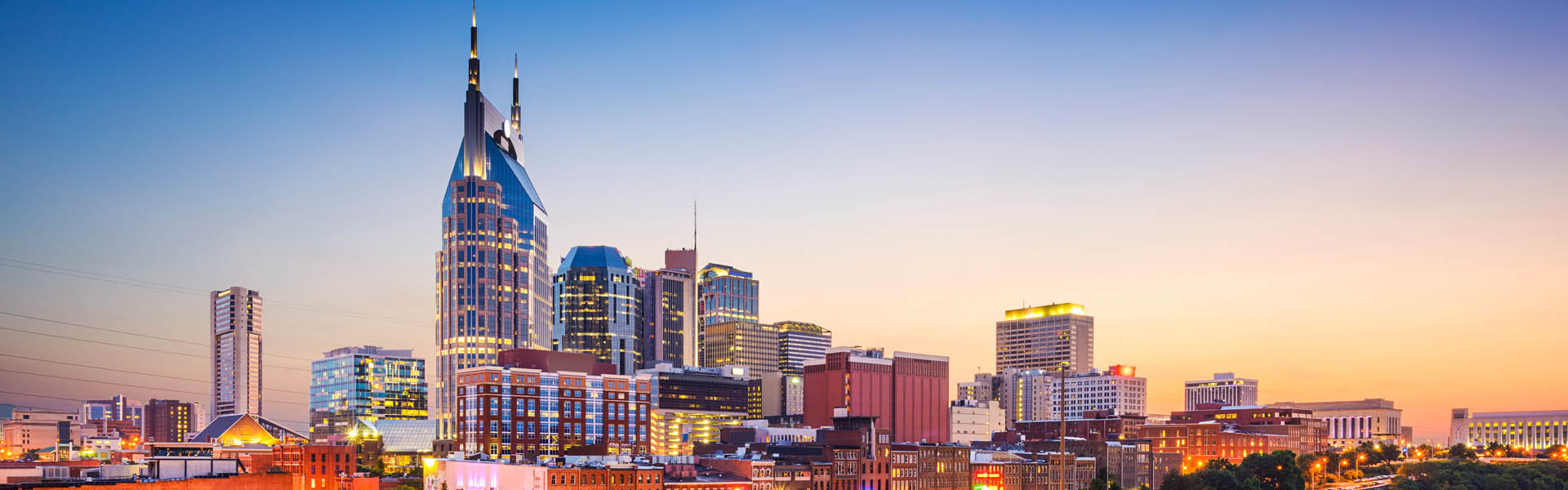 Neon color image of a band playing and people singing along